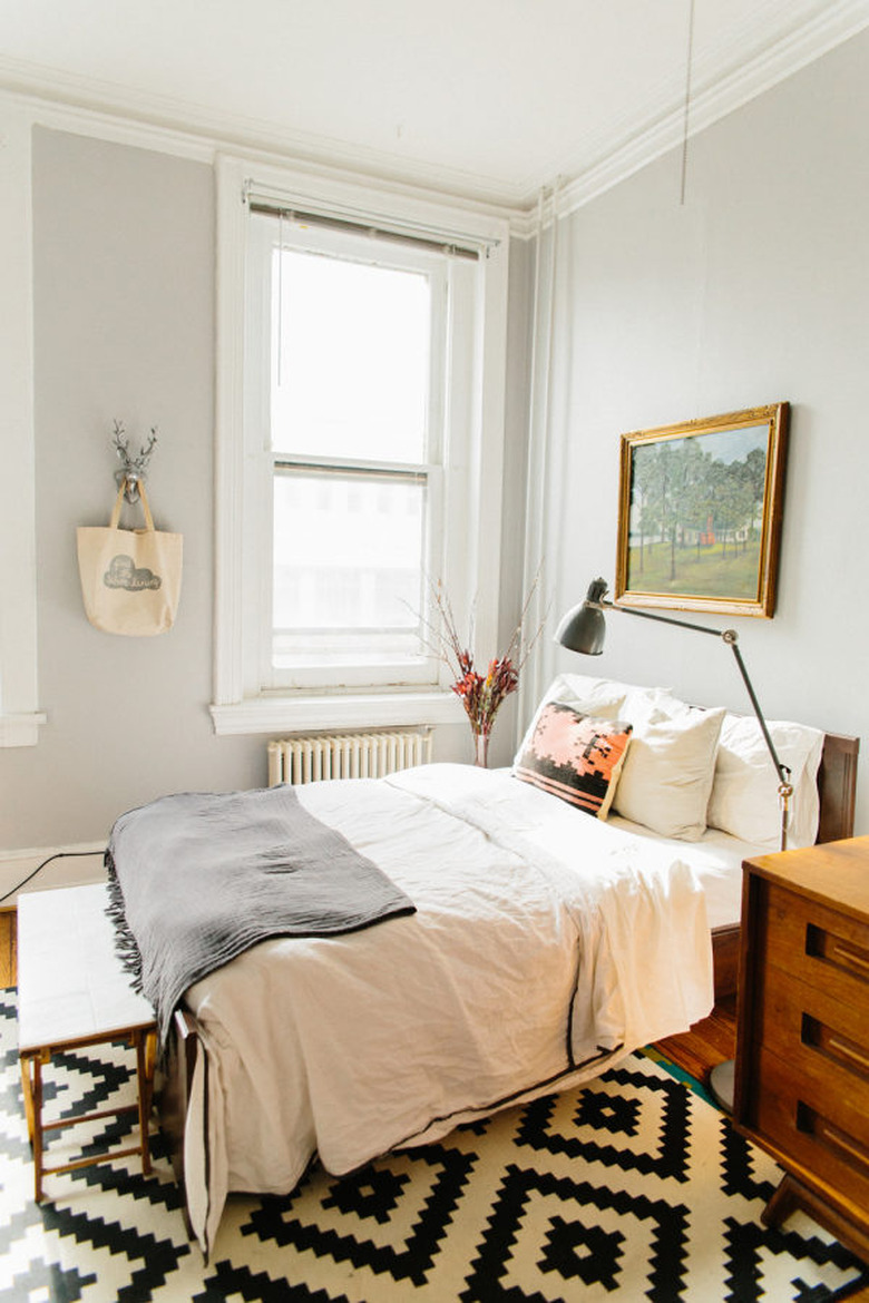 eclectic bedroom with task floor lamp and black and white graphic rug