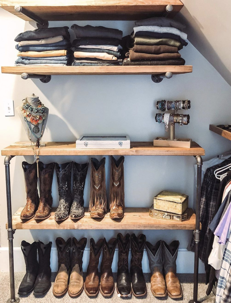 Custom industrial closet ideas with wood shelves and cowboy boots