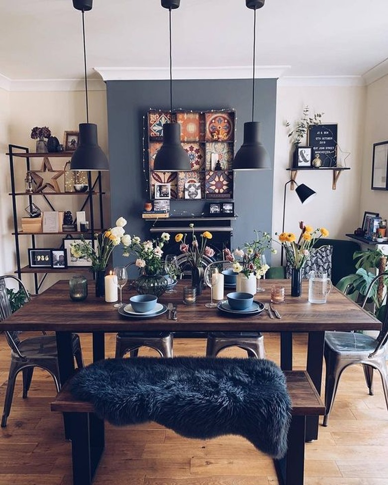 boho industrial dining room idea with blue accent wall