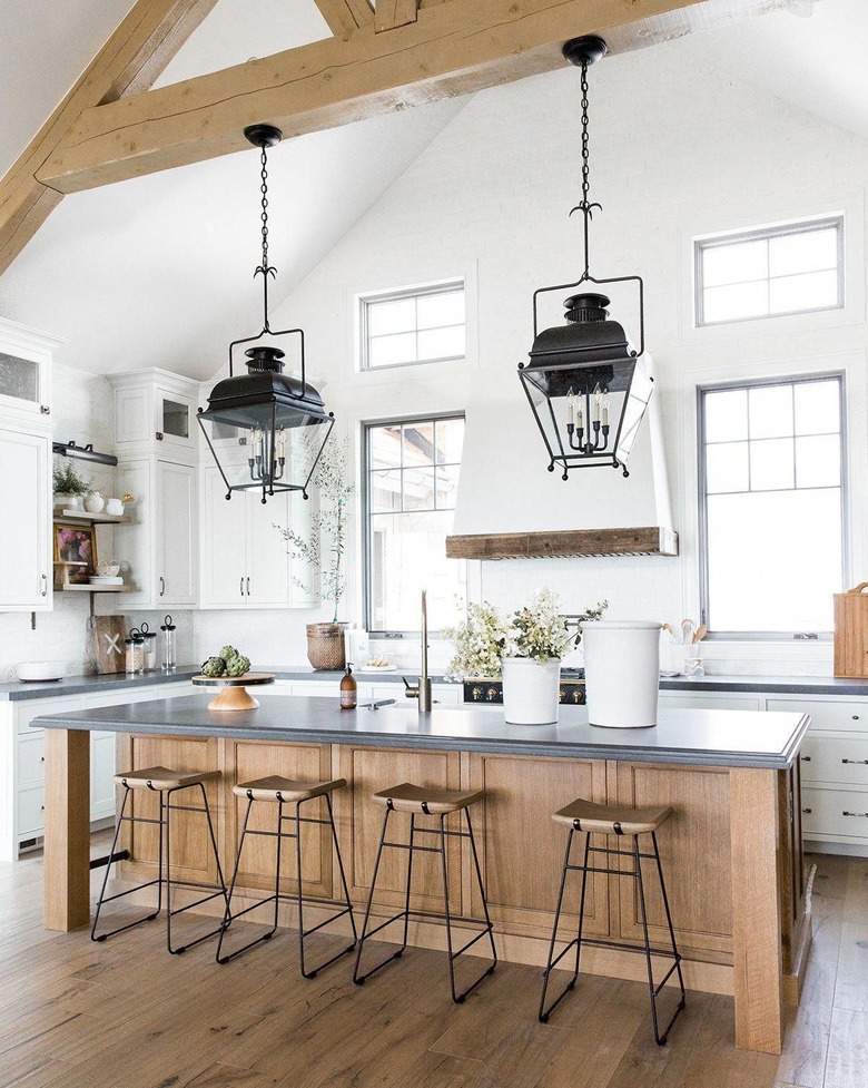 white and wood industrial kitchen with black hanging lanterns