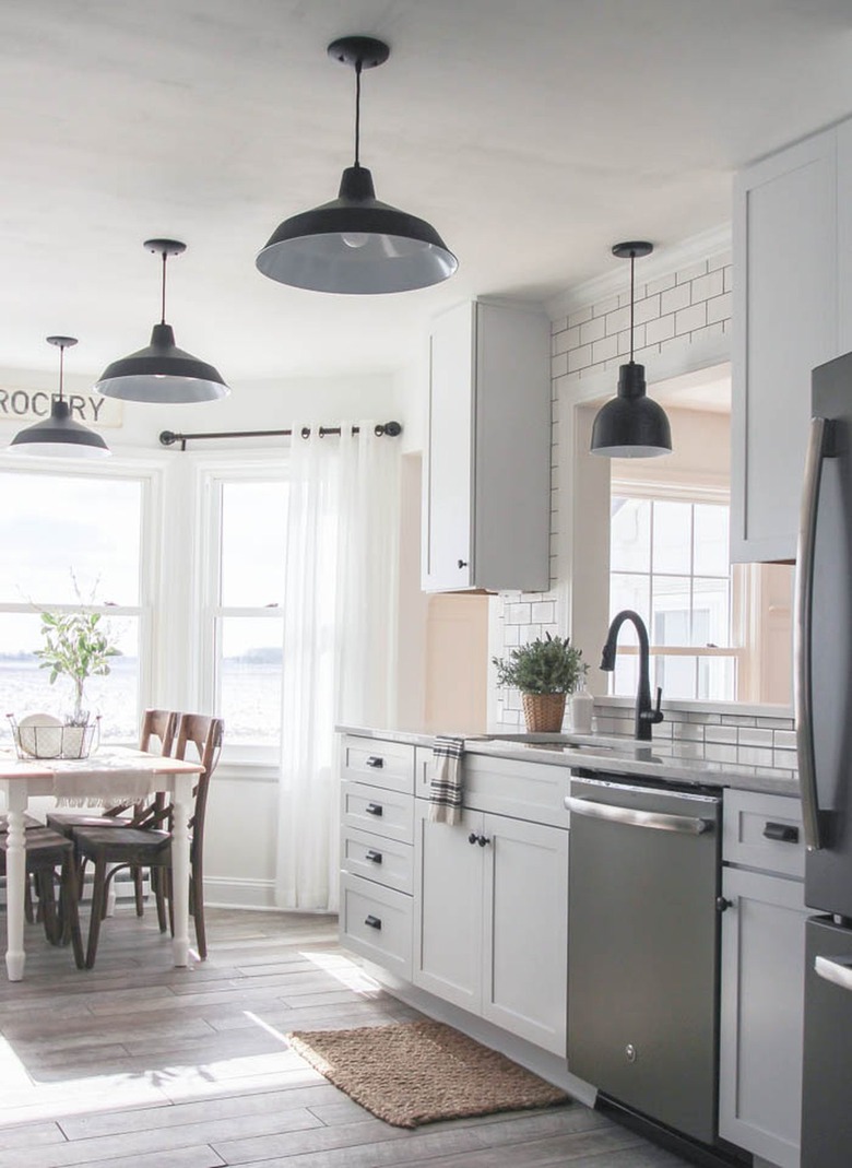 black oversize barn lights in white industrial farmhouse kitchen