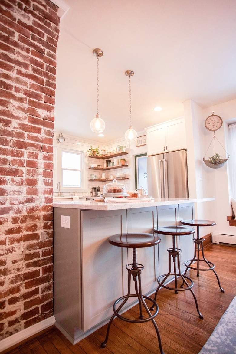 small industrial kitchen with exposed brick post