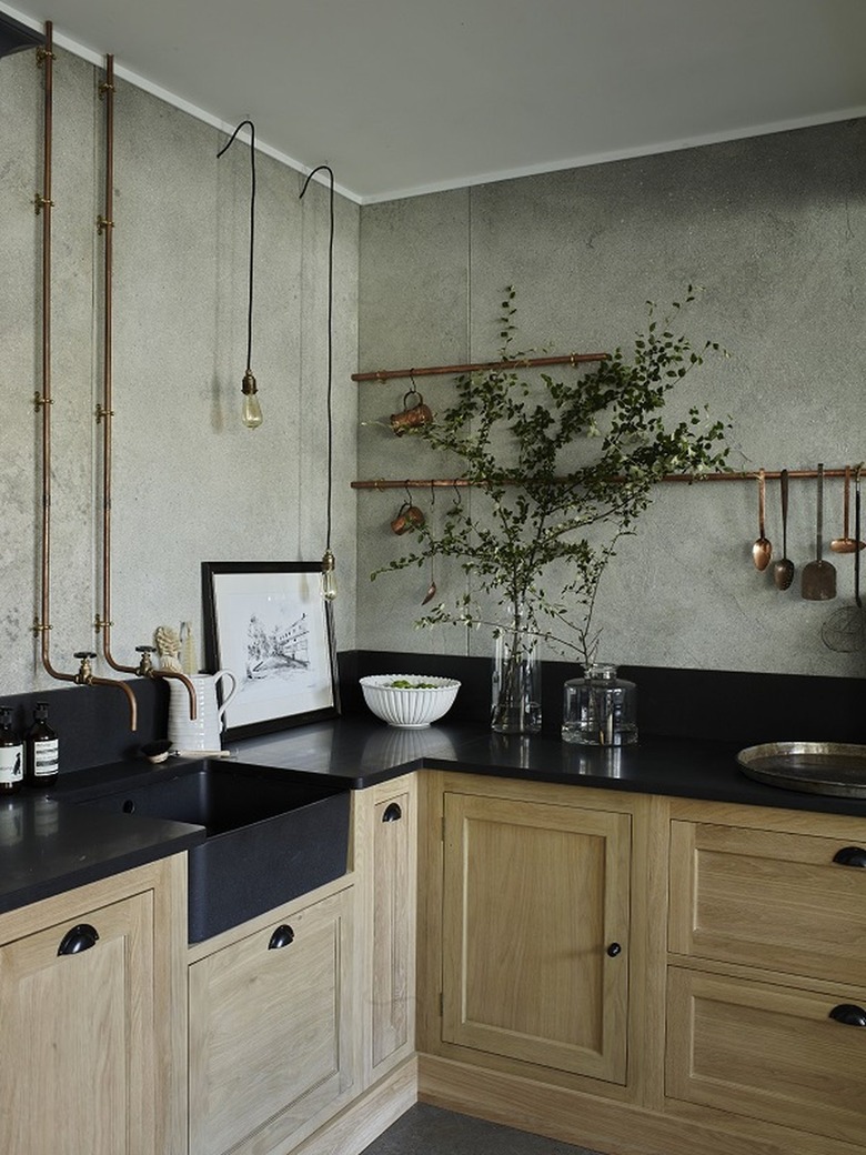 industrial kitchen with exposed copper pipes on wall