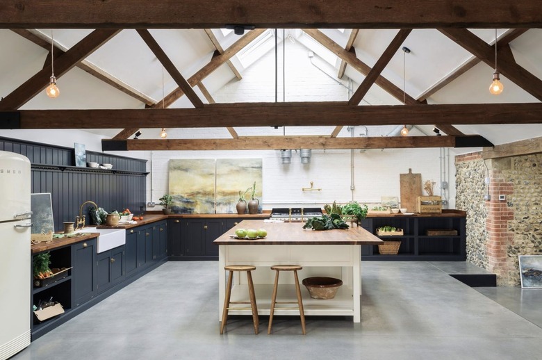 industrial kitchen with concrete floor and wood beams