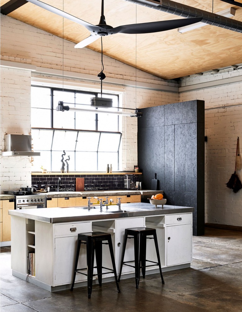 industrial kitchen with high ceilings and oversized fan