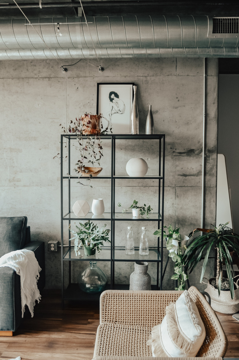 industrial living room idea with wood flooring and exposed HVAC pipes