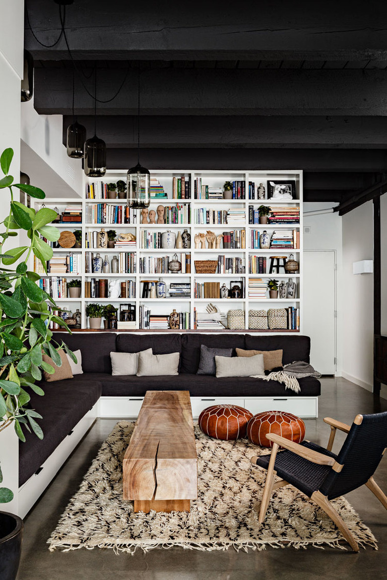 living room with black ceiling and built-in sofa