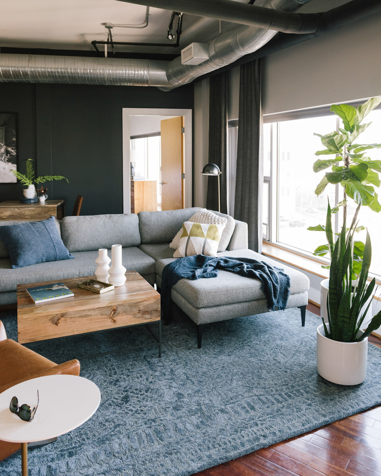 industrial style apartment living room with exposed HVAC system