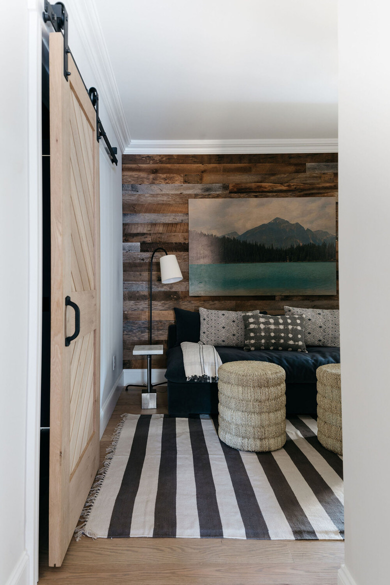 living room with industrial wallpaper that looks like reclaimed wood planks