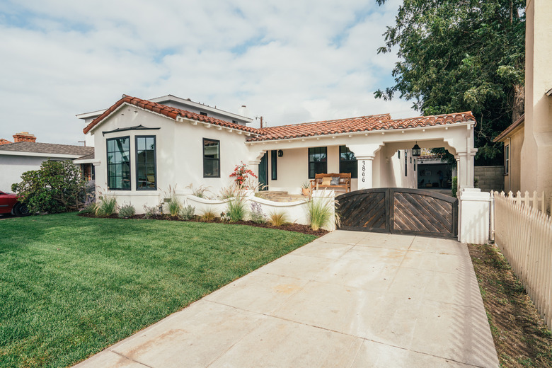 Home exterior and front yard. California-Spanish style.