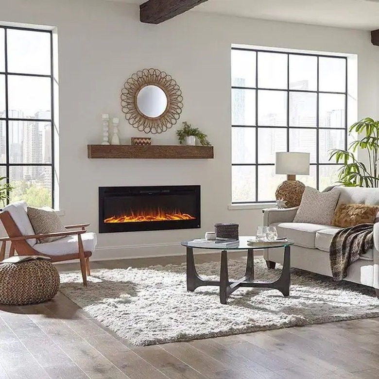 A recessed electric fireplace in a white, modern living room