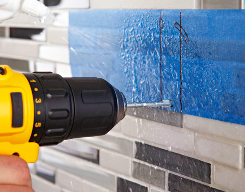 Drilling through a shower wall.