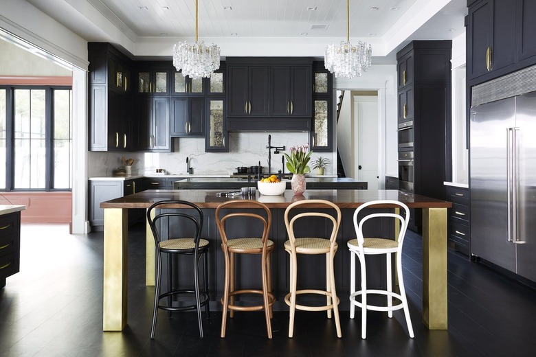 kitchen with black cabinets and thonet bar stools