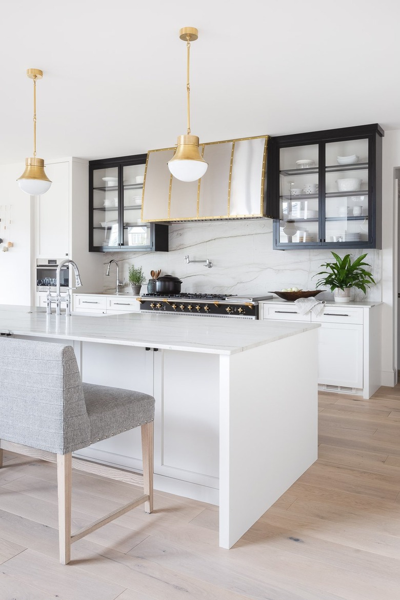 black and white kitchen with marble slap backsplash