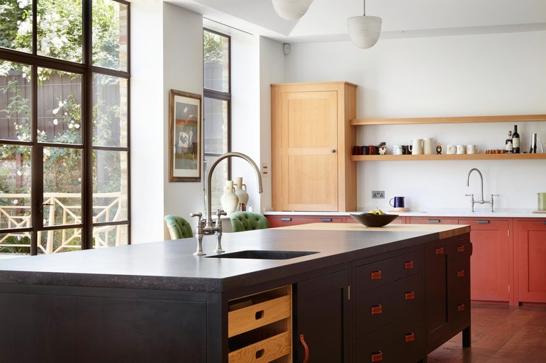 island with black kitchen cabinets and leather pulls