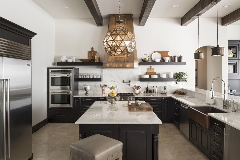 large traditional kitchen with black cabinets and copper details