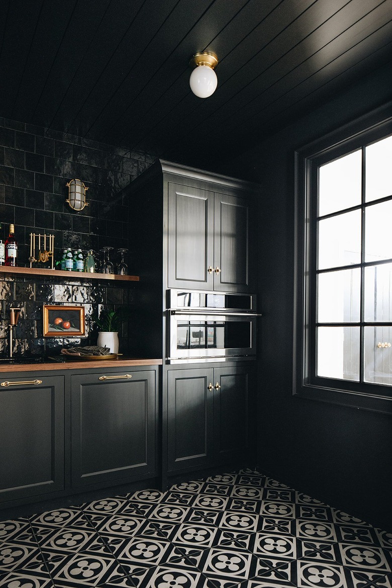 black kitchen with pattern floor tiles and open shelving