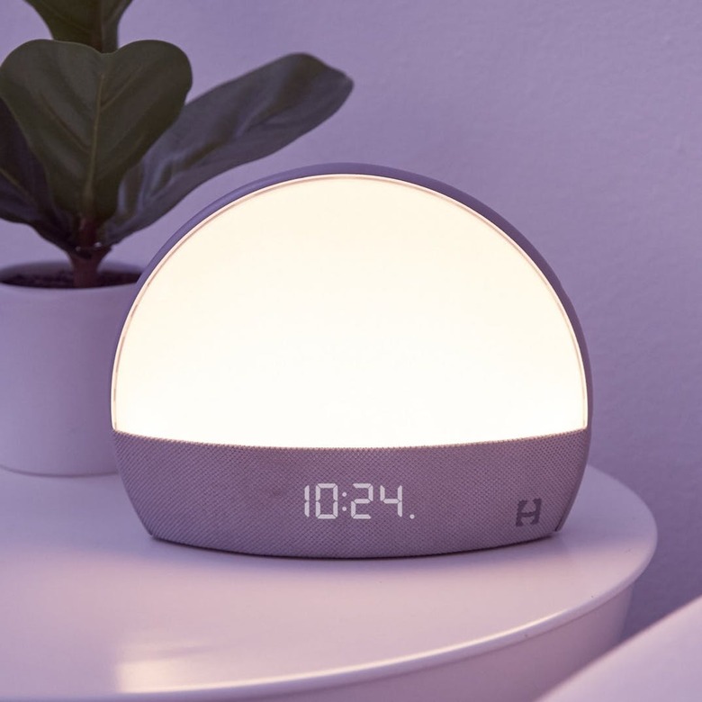 Hatch Restore Smart Light and Sleep Sounds next to plant on nighstand