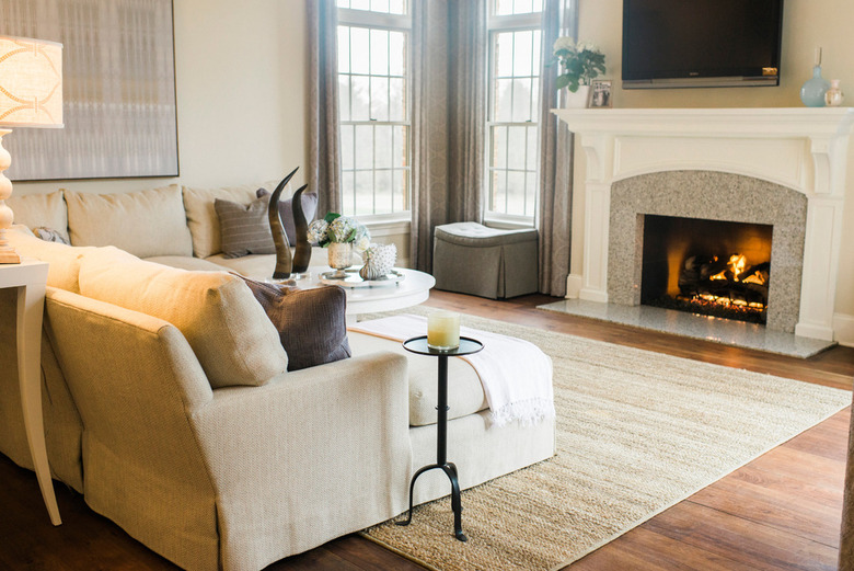 beige living room idea with gray accents and fireplace