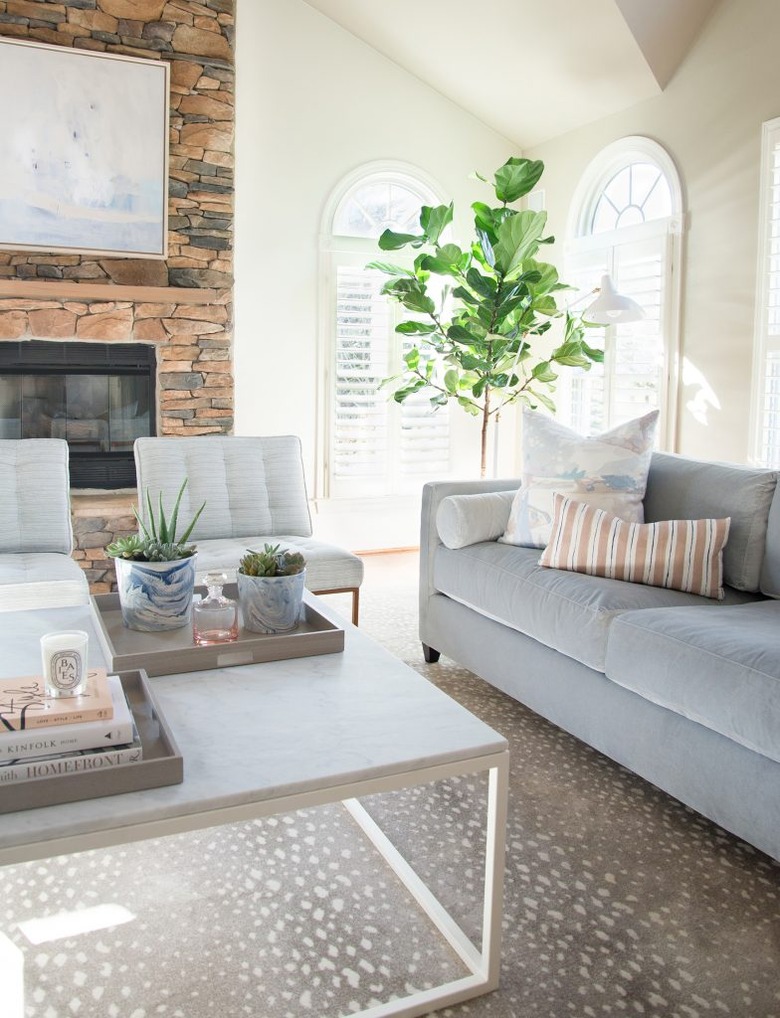 beige living room idea with gray sofa by elizabeth lawson design