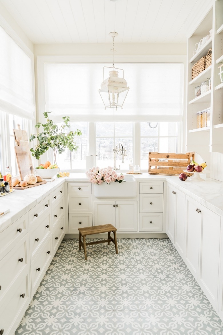 ivory color idea in pantry with ivory cabinets and patterned floor tile