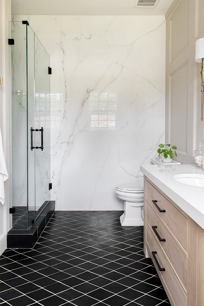 ivory color idea in bathroom with marble wall and black floor tile