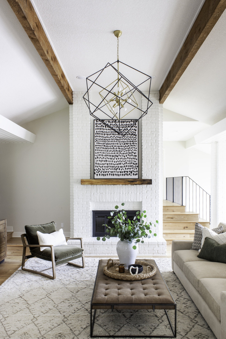 ivory color idea in sitting room with painted fireplace and modern light fixture