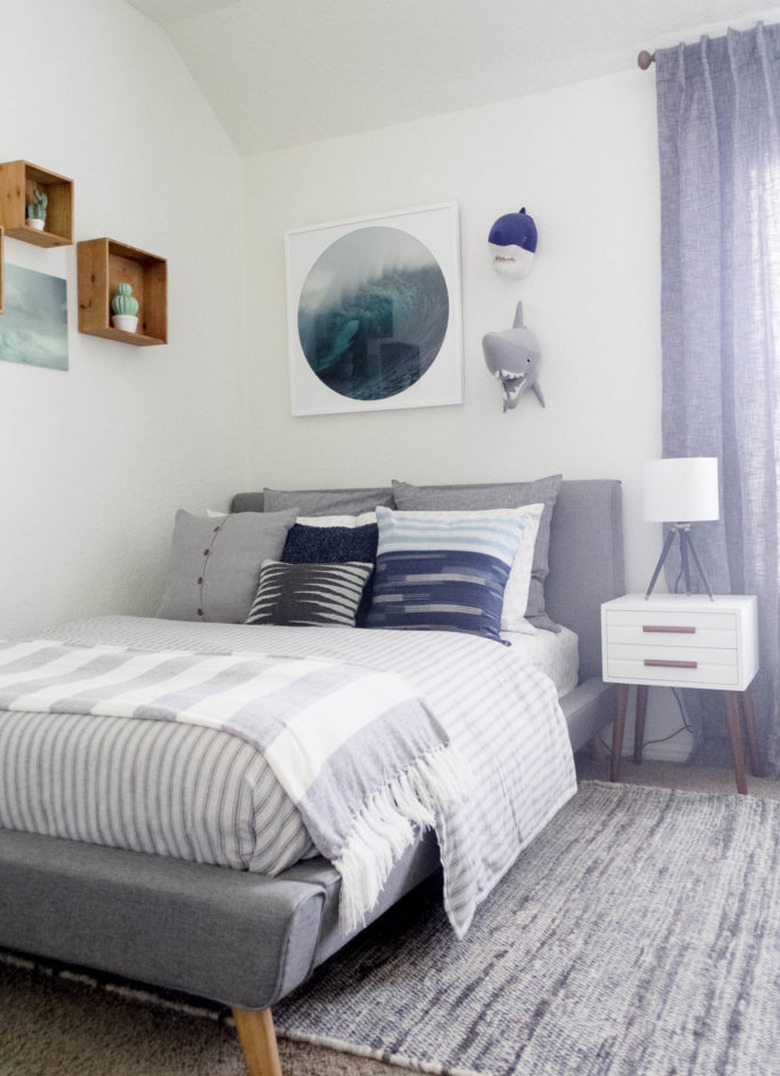 Kids' minimalist bedroom with ocean decor and striped bedding