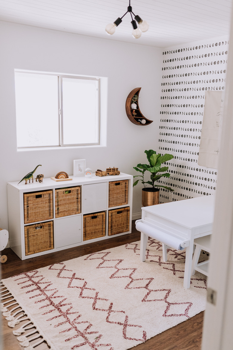 kids' playroom idea with storage and patterned wallpaper on wall