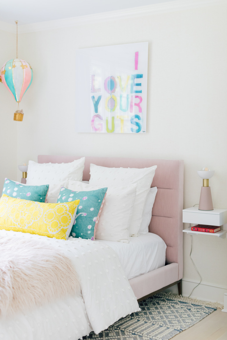 Kids' room organization with small bedside shelf and with colorful decor