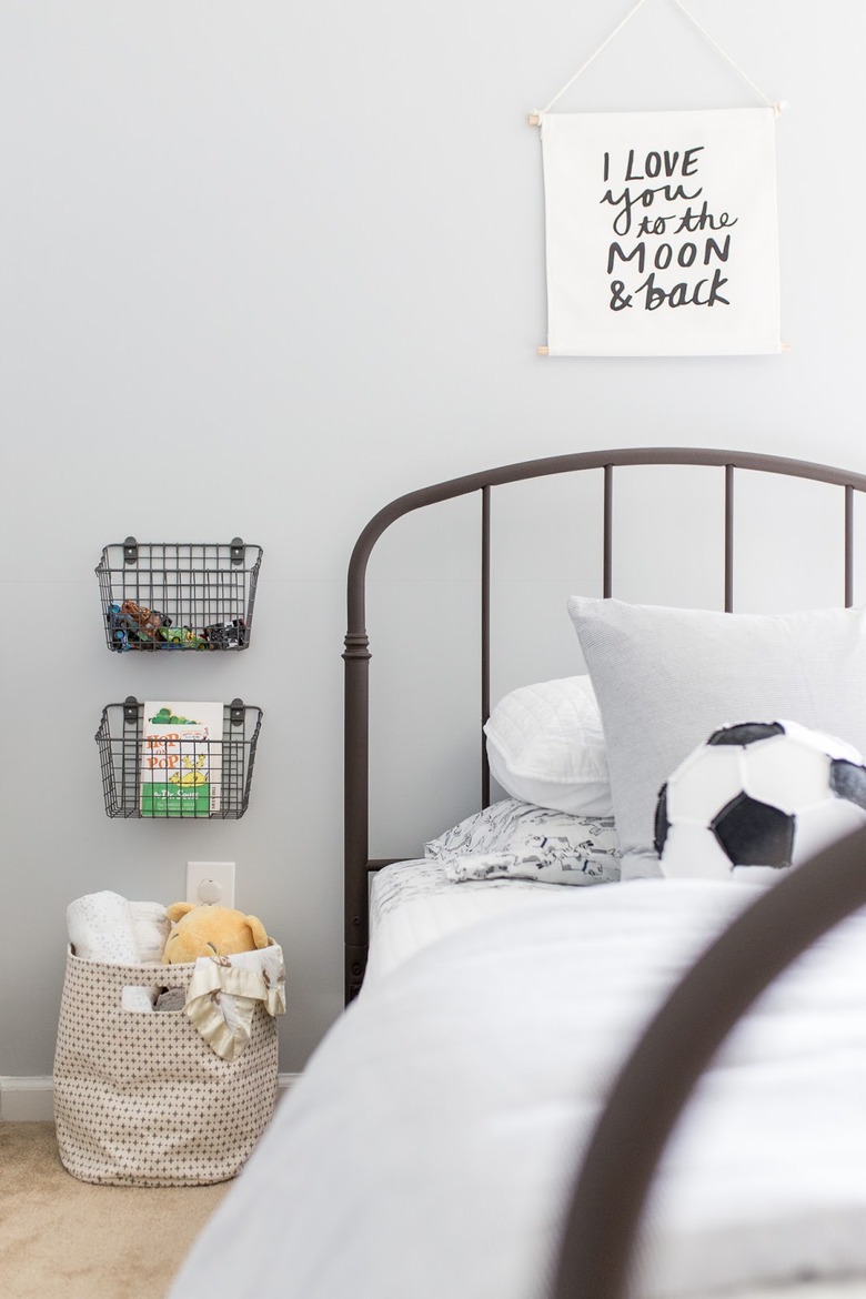 Kids' room organization with wire wall baskets and metal bed frame