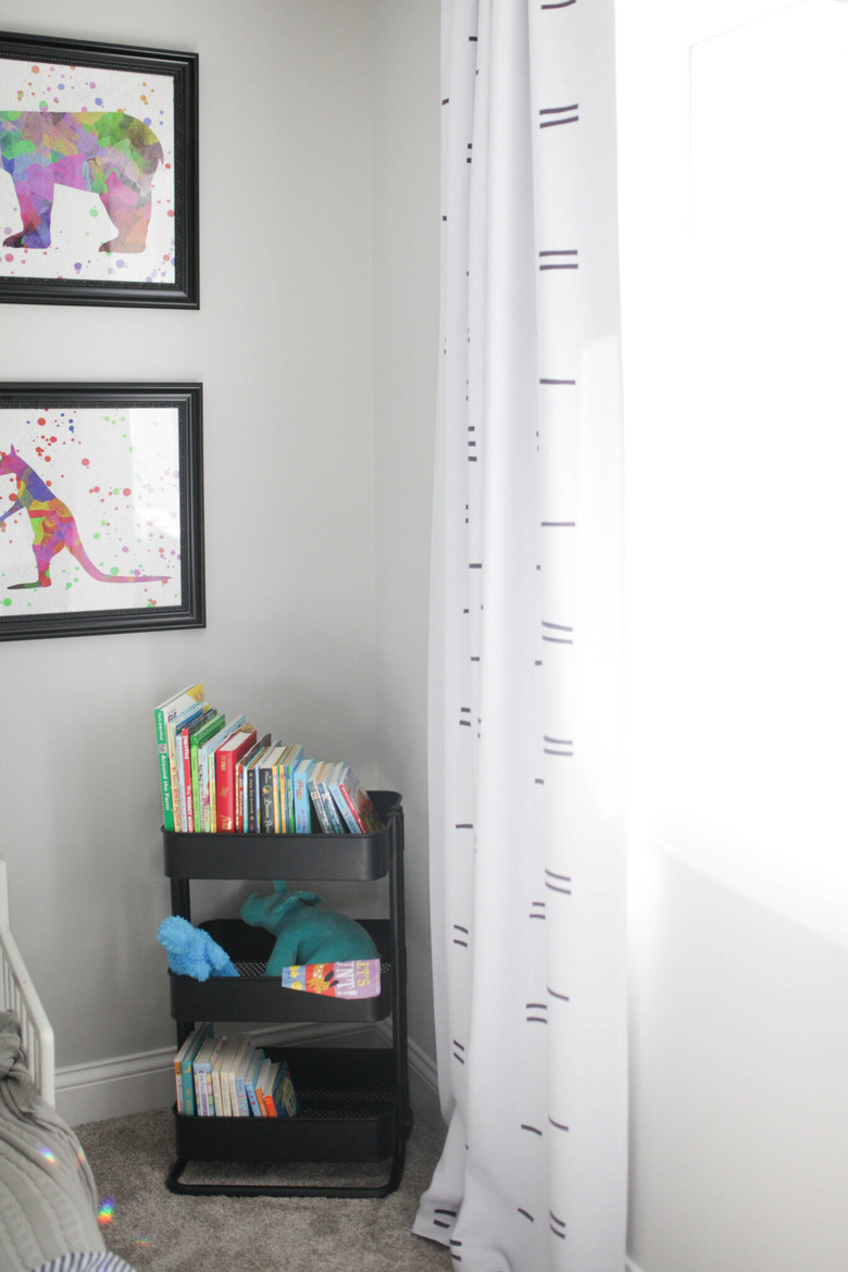 Kids' room organization with black bar cart as bookshelf with books