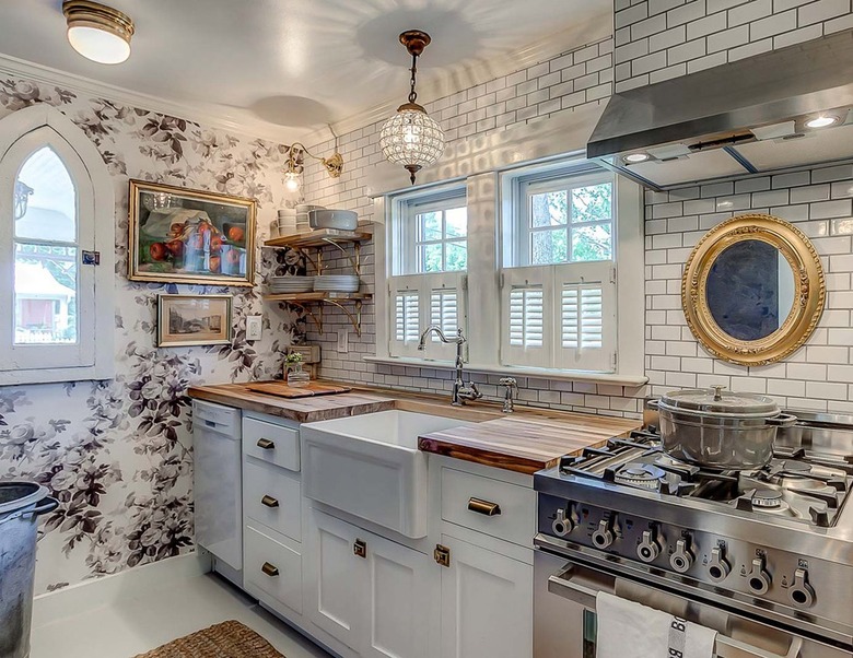 floral kitchen accent wall with white cabinets and backsplash