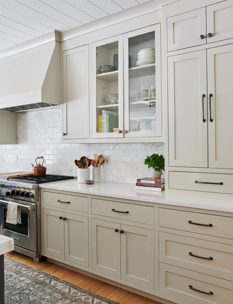 greige kitchen cabinet color with white countertops and white subway tile backsplash