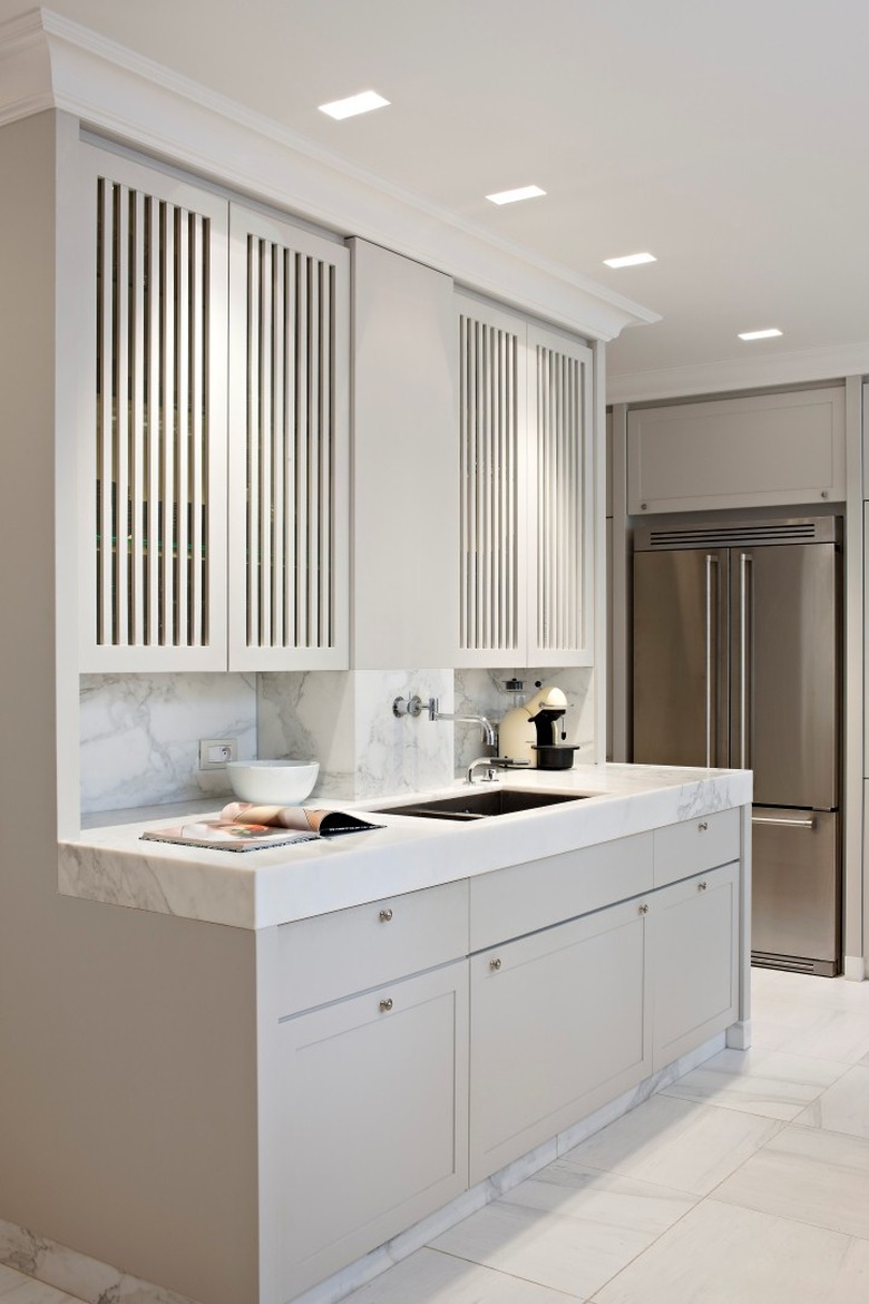 kitchen cabinet style with louvered upper cabinets and thick edge marble countertop