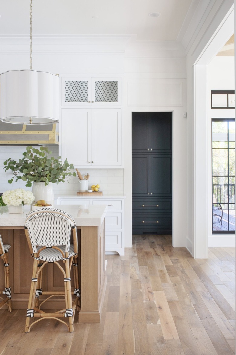 all white traditional kitchen with white cabinets and leaded glass panels