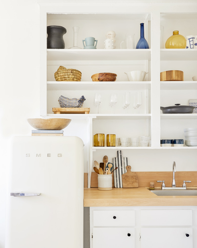 kitchen cabinet style with white cabinets and open shelving and wood countertops