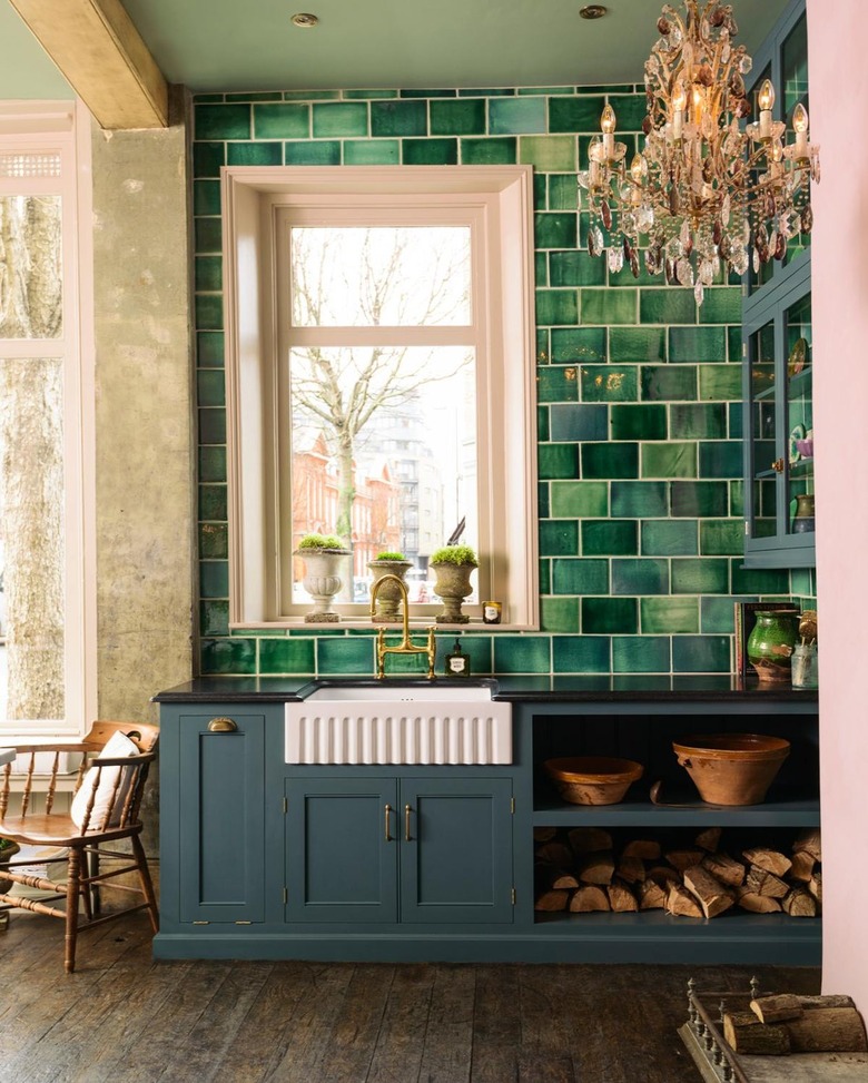 green and pink kitchen with ornate chandelier