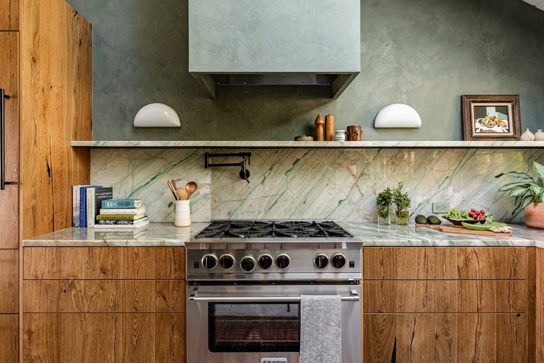 kitchen with brown cabinets and green walls