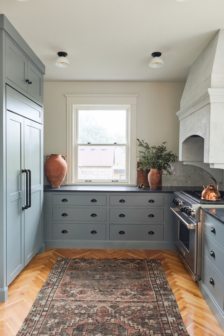 Dusty blue kitchen colors on cabinets in galley kitchen