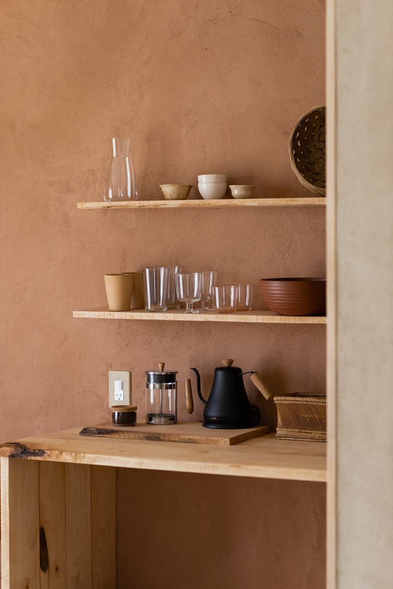 Terra cotta kitchen colors in small kitchen with floating wood shelves