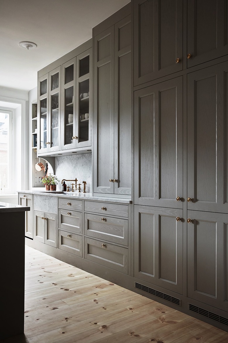 Kitchen with hardwood floors and tall cabinets.