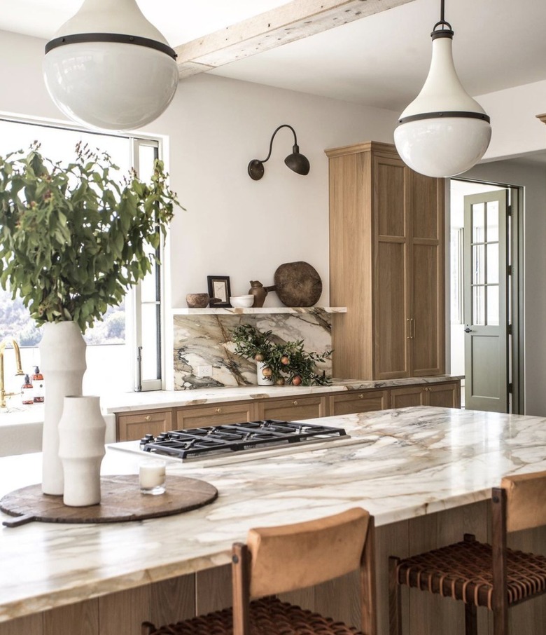 Rustic kitchen with natural wood cabinets and marble countertops.