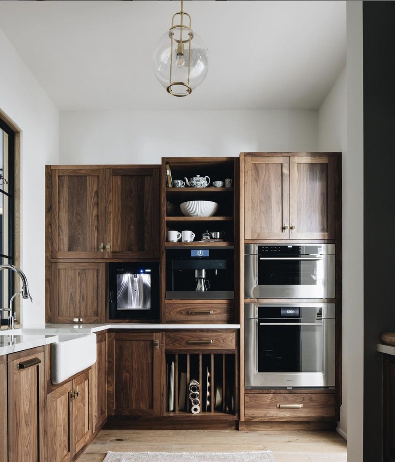 Kitchen with brown wood cabinets and a farmhouse sink.