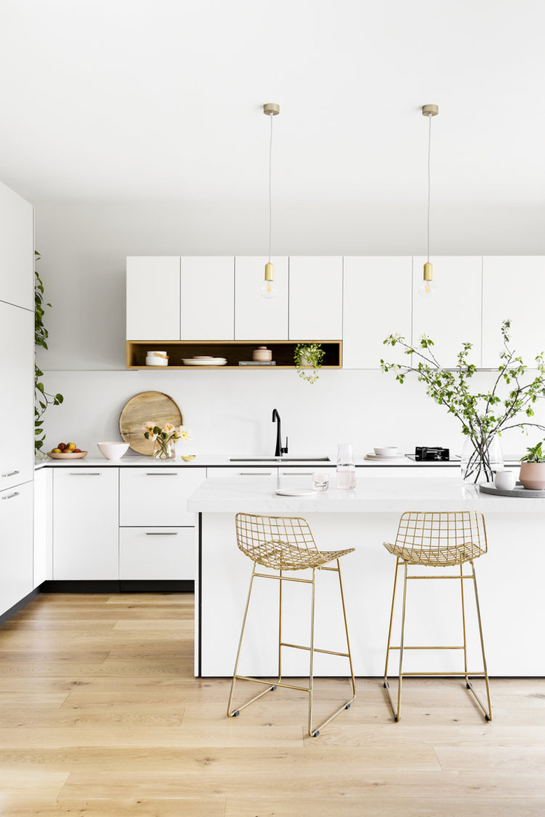 hardwood kitchen flooring with white cabinets and pendant lighting  over island