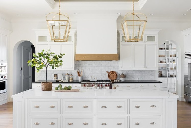 kitchen island decor in white kitchen with subway tile backsplash and wood floor