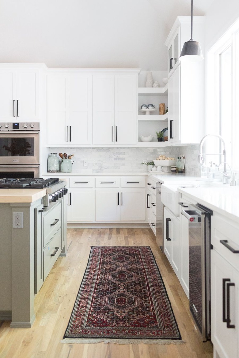 Kitchen island with stove and green cabinets