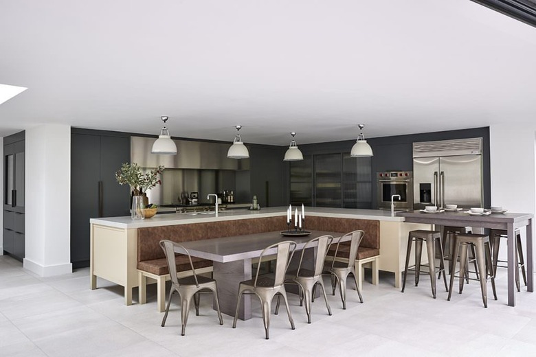 kitchen island with bench seating in modern and industrial kitchen with wood island and metal chairs