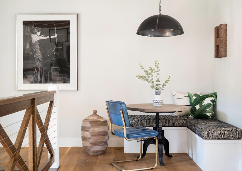 Kitchen nook idea with blue vinyl chair at a small round table in a modern dining nook