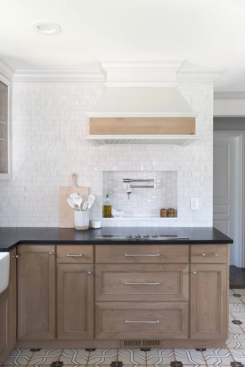 marble tile backsplash with wood cabinetry in modern kitchen